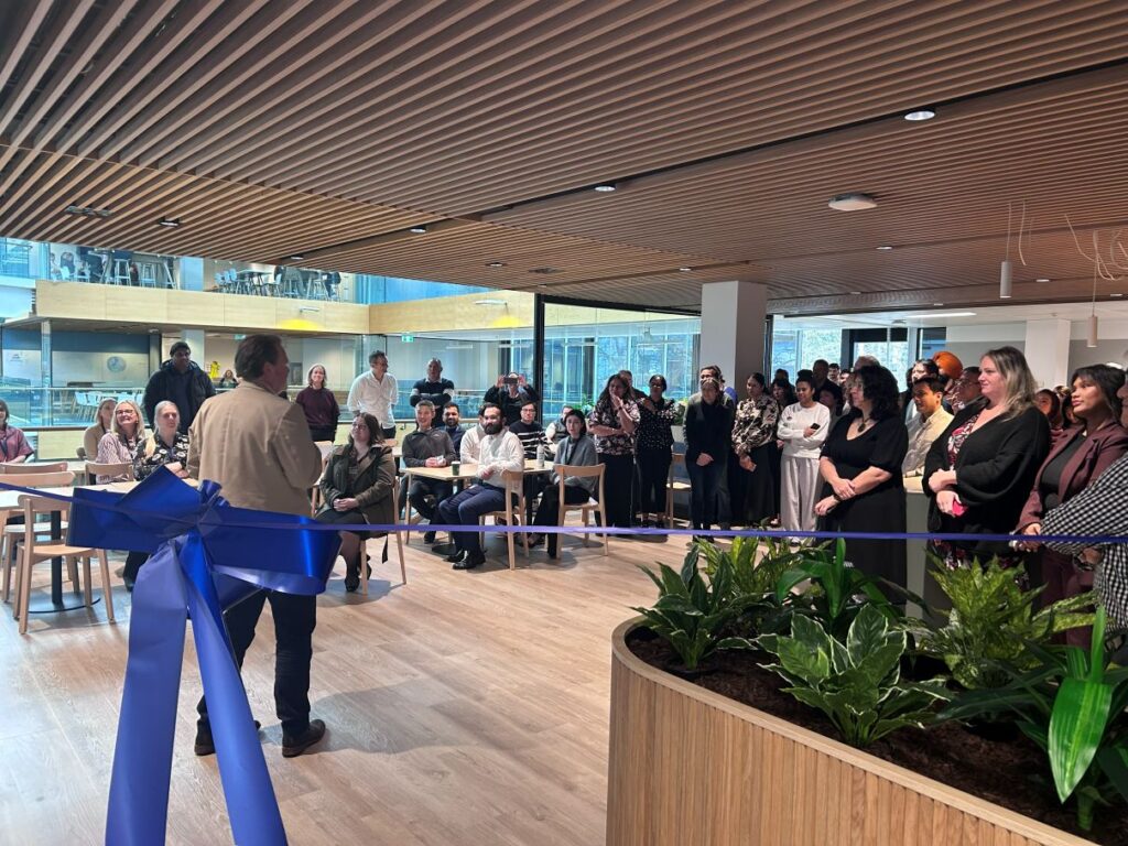 Finance Now Auckland team members listening to CEO Hadyn Halls' welcoming speech in the new office space on Victoria Street, Auckland CBD